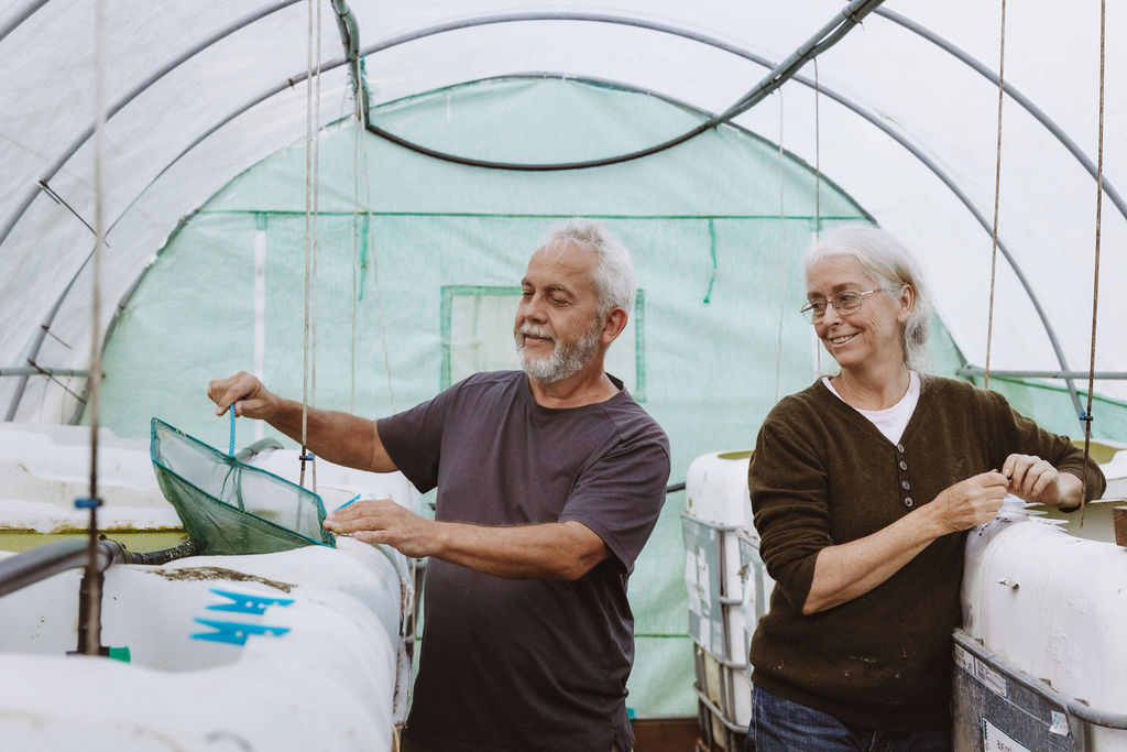 Trevor and Anna in one of their fish breeding tents